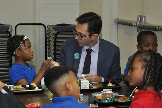 Acting Deputy Under Secretary Brandon Lipps eating his school lunch alongside students